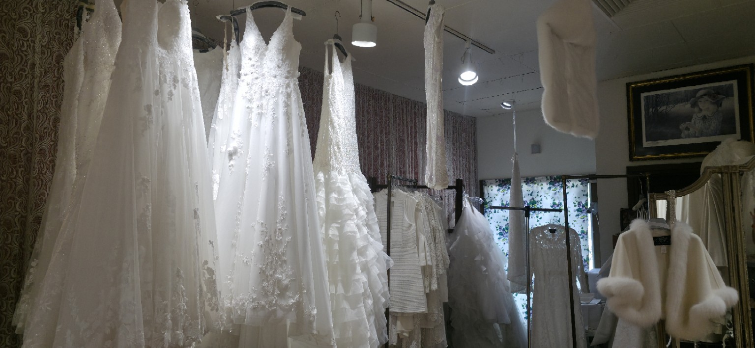 White wedding dresses suspended in a gallery fashion exhibition