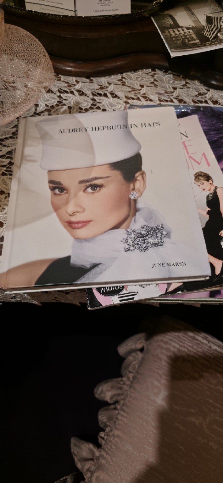 A vintage fashion magazine displayed among textiles and accessories