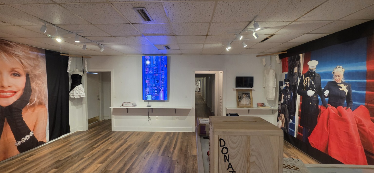 Cotton Street Gallery exhibit with a 65-inch television mounted vertically on the central wall