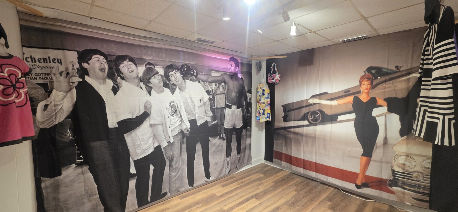 Pop-culture exhibition with large photographic murals and vintage dresses