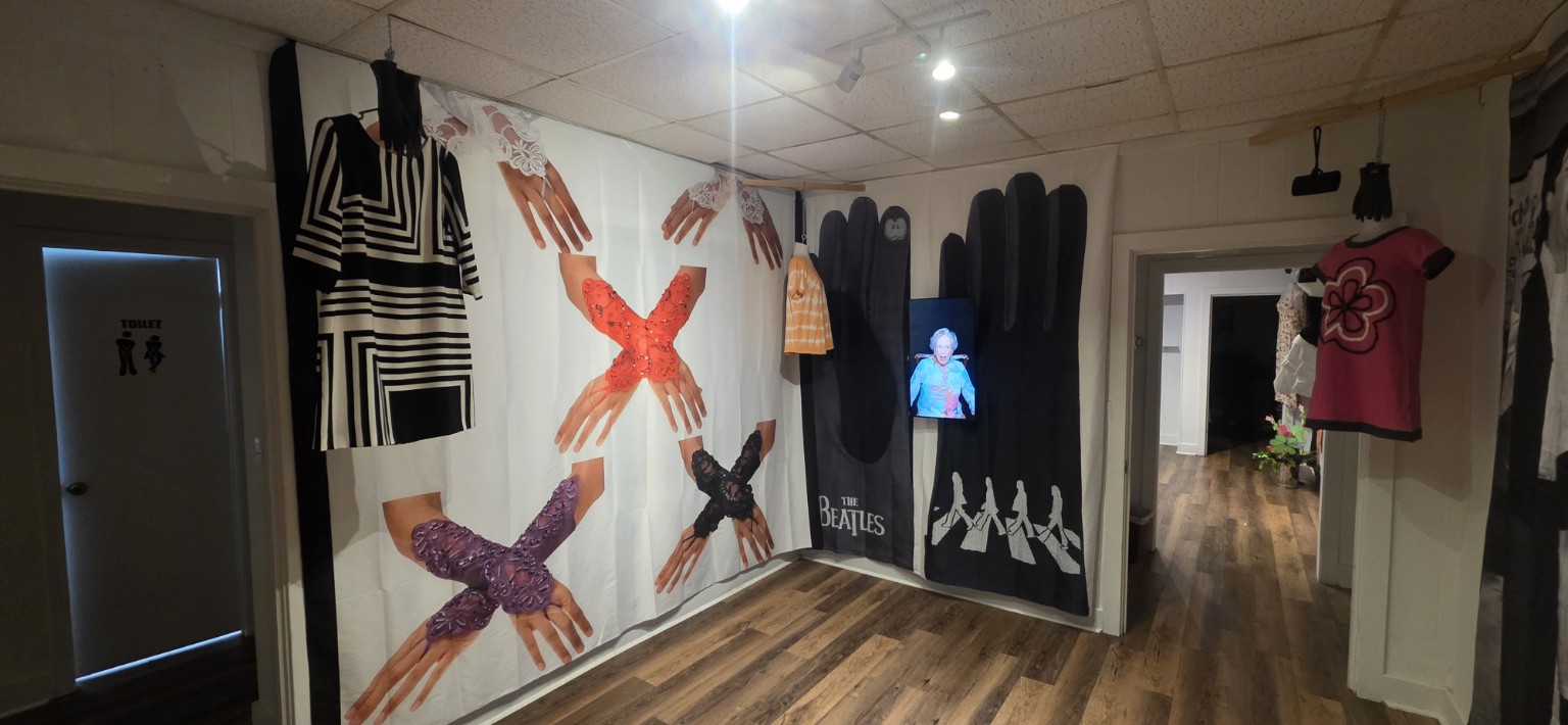 Exhibition of decorative gloves and vintage dresses with an interview screen