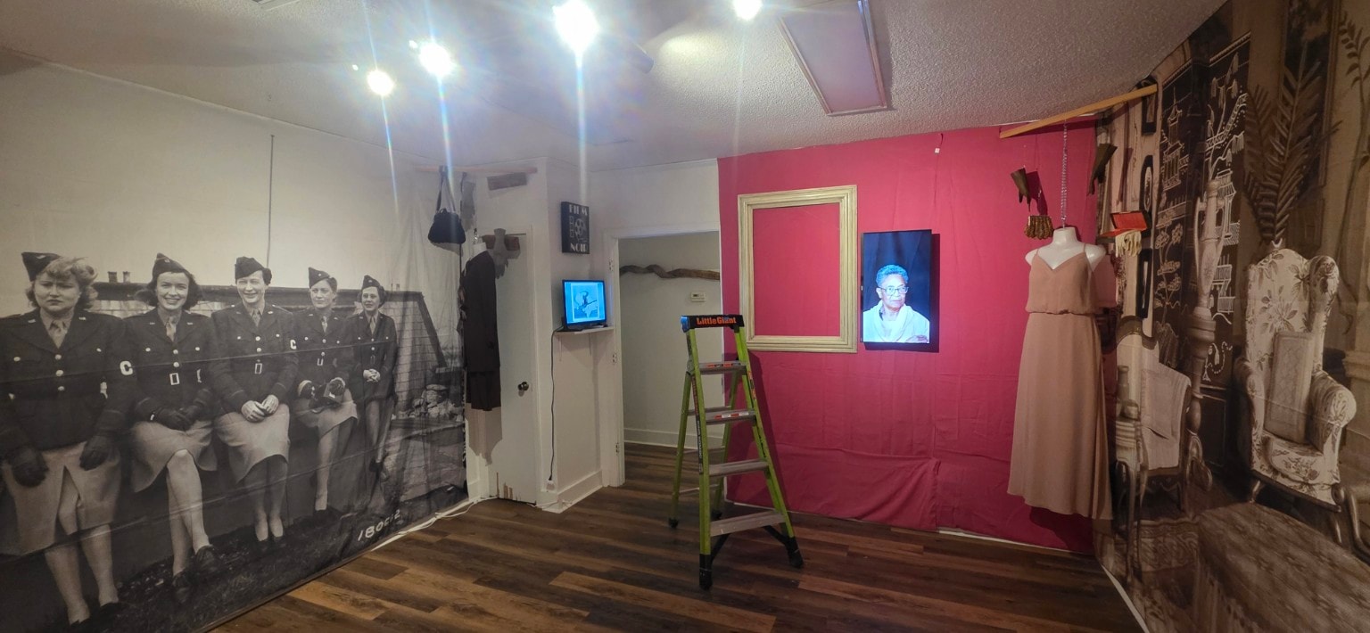 Cotton Street Gallery exhibit with interview videos playing on wall-mounted displays
